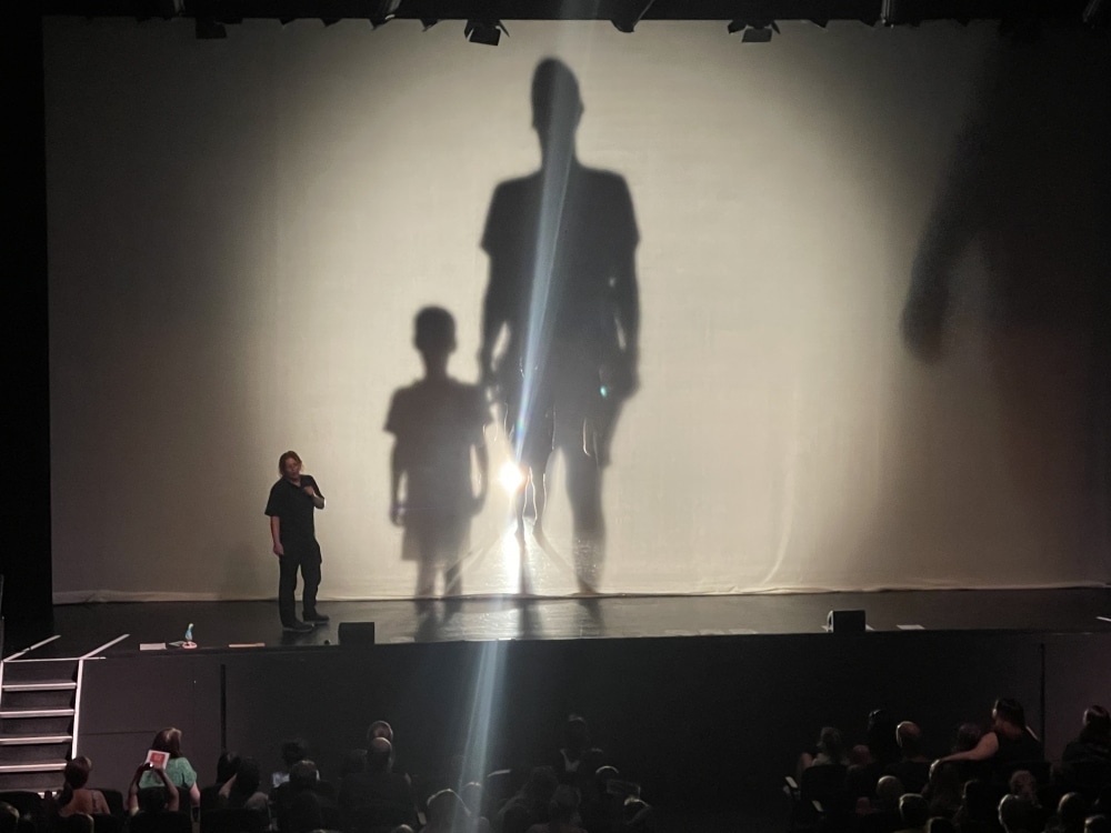 Man on stage with shadow special effects