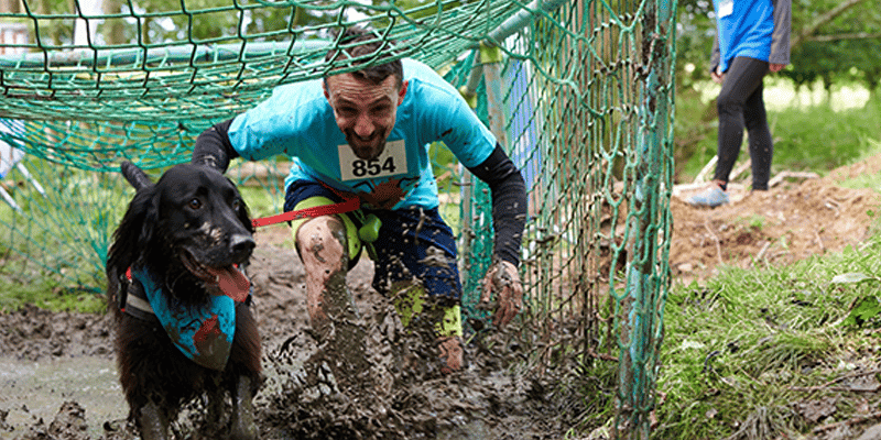 Hundreds trudge through the mud for dog fundraiser