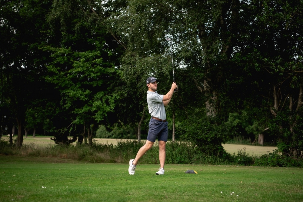 Golfers tee off on the green to put charities in the black